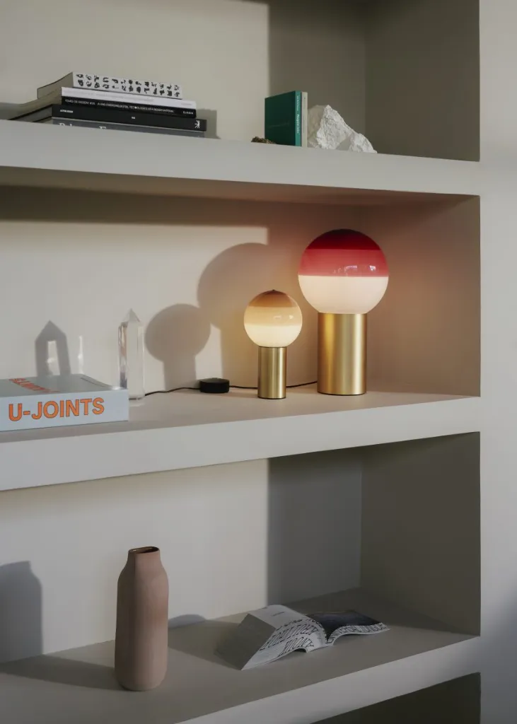 marset-lr-dipping-light-burgundy-and-cream-on-a-shelf-857x1200.webp
